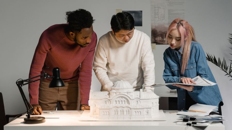 Reviewing a building design and plans together at a desk